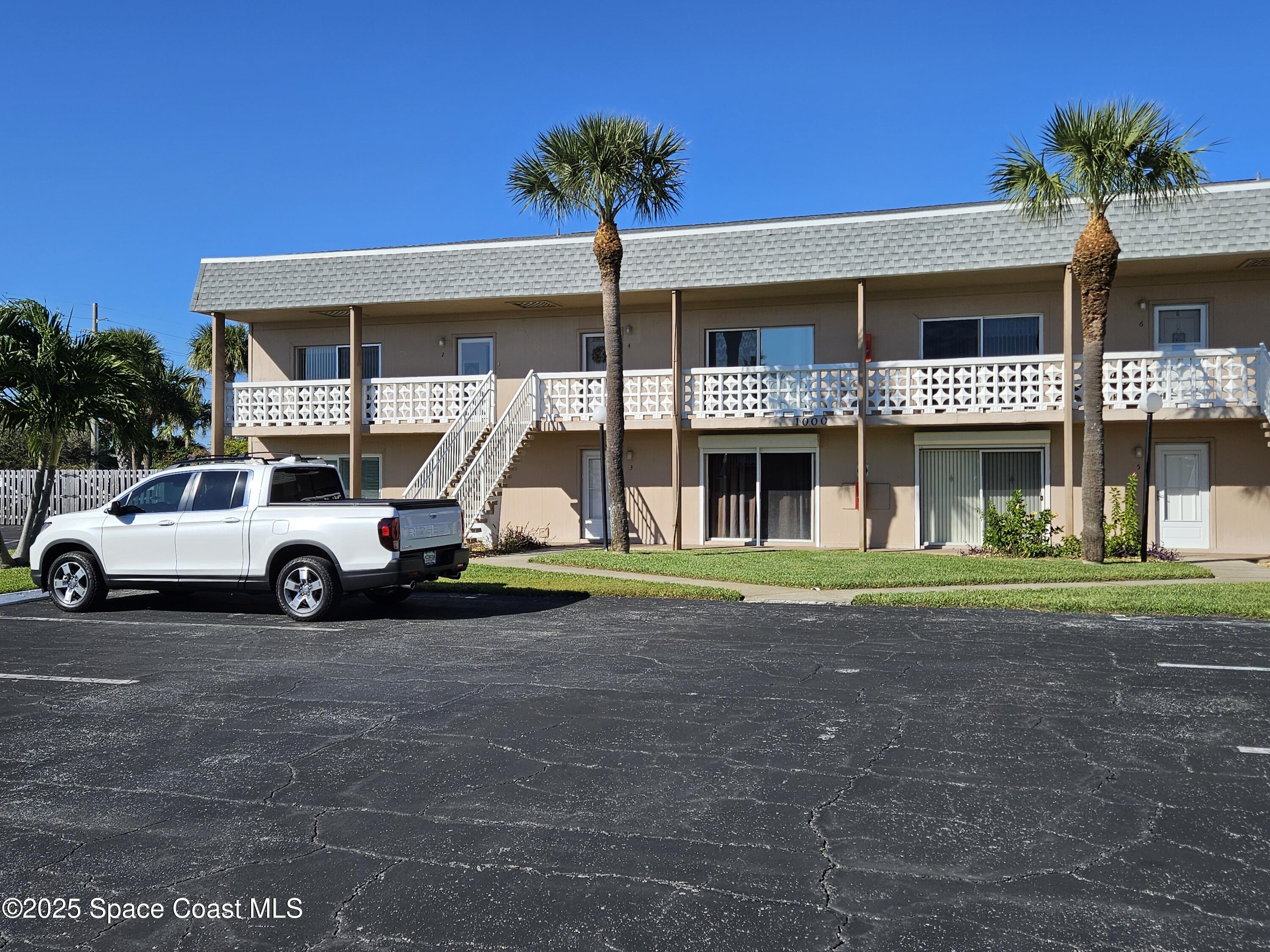 3150 North Atlantic Avenue, Unit 21000 Cocoa Beach, FL 32931 - Photo 1 of 1 a car parked in front of a building