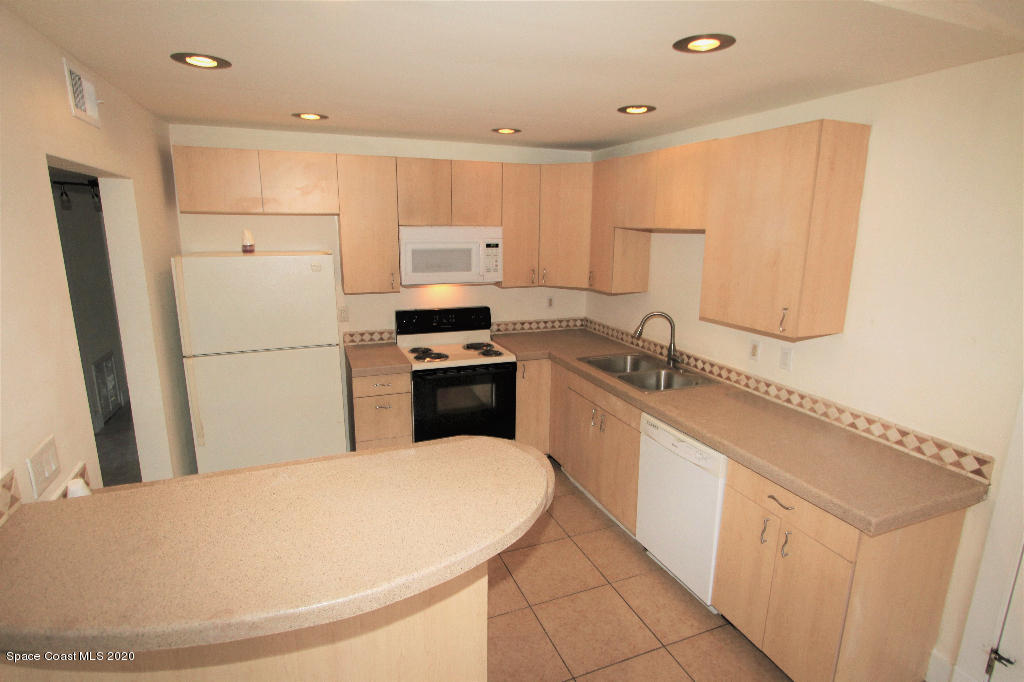 809 8th Street Merritt Island, FL 32953 - Photo 5 of 21 a kitchen with stainless steel appliances a refrigerator sink and microwave
