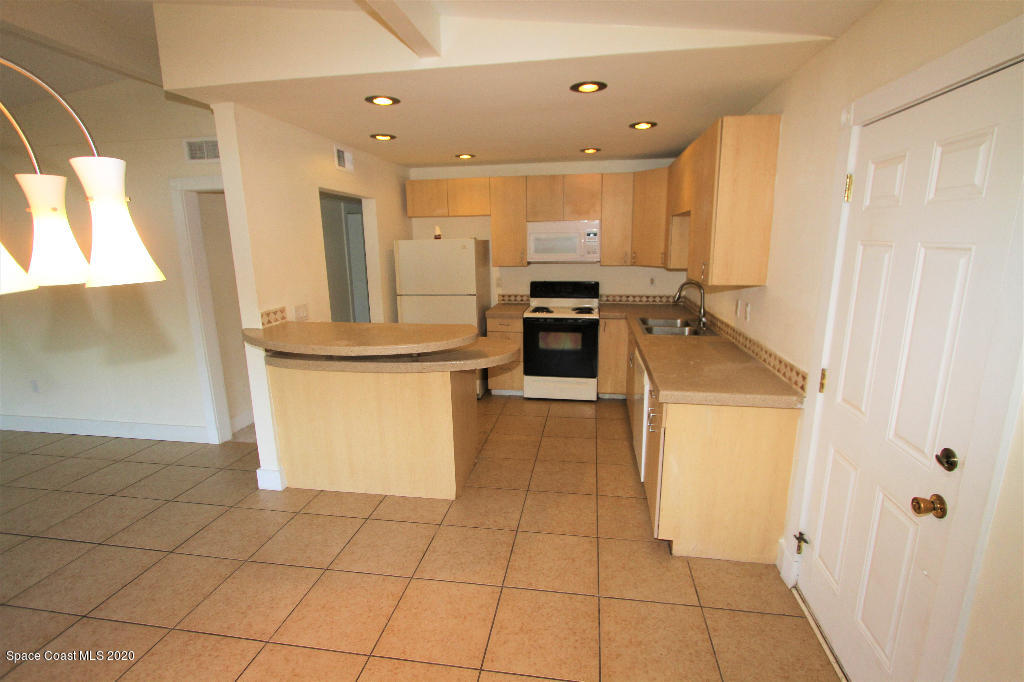 809 8th Street Merritt Island, FL 32953 - Photo 6 of 21 a kitchen with stainless steel appliances a refrigerator and a stove