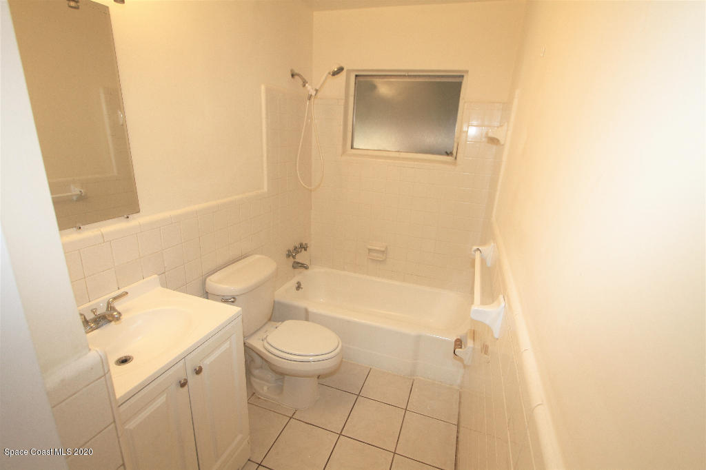 809 8th Street Merritt Island, FL 32953 - Photo 9 of 21 a bathroom with a sink a toilet and shower