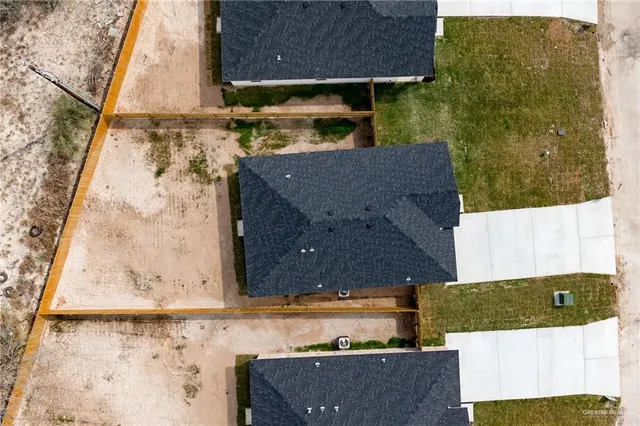 aerial view of a house with a yard