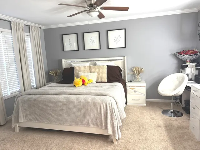 a bedroom with a bed and a chandelier