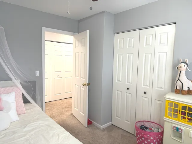 a view of bedroom with a bed and a window