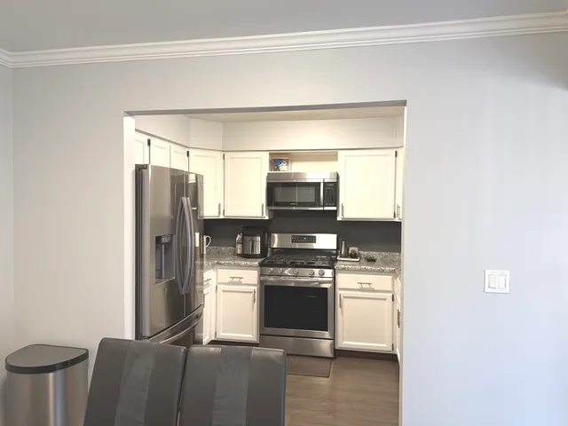 a kitchen with stainless steel appliances a refrigerator and a stove top oven