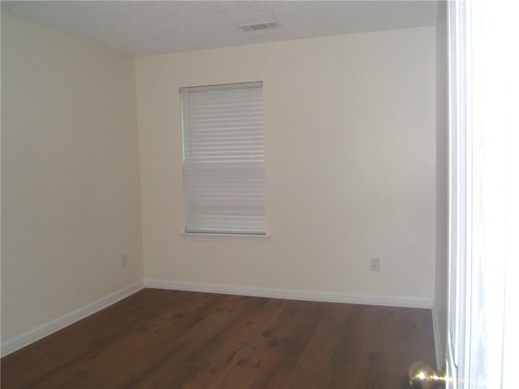 7202 Georges Way Morrow, GA 30260 - Photo 6 of 11 a view of an empty room with wooden floor and a window