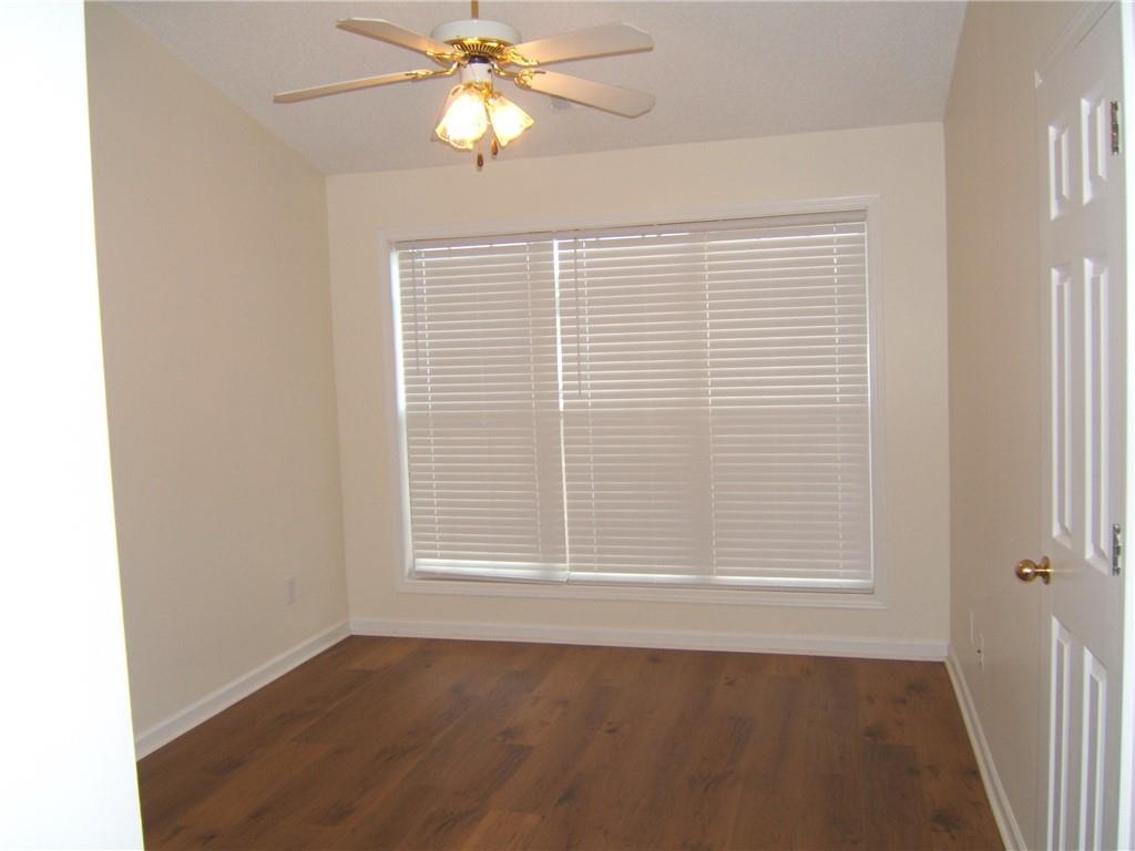 7202 Georges Way Morrow, GA 30260 - Photo 7 of 11 an empty room with wooden floor fan and windows