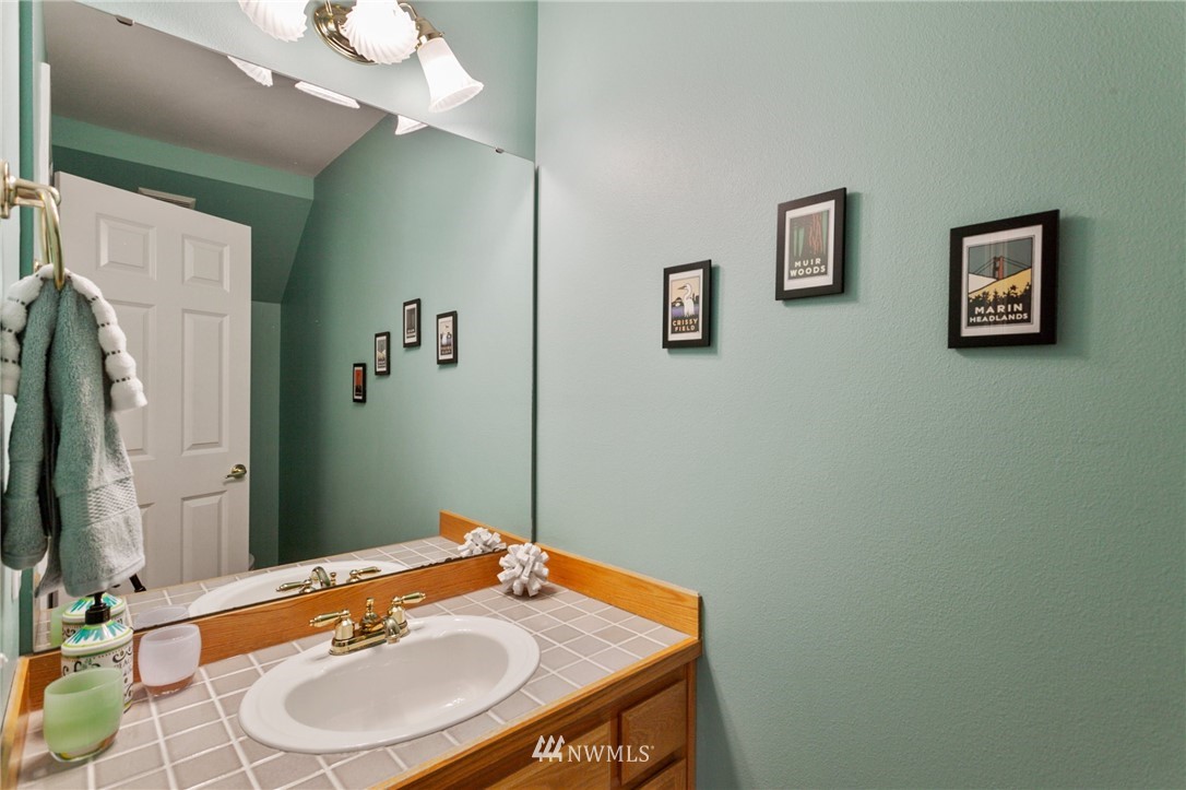 913 232nd Street Southwest Bothell, WA 98021 - Photo 14 of 34 a bathroom with a sink a mirror and a toilet
