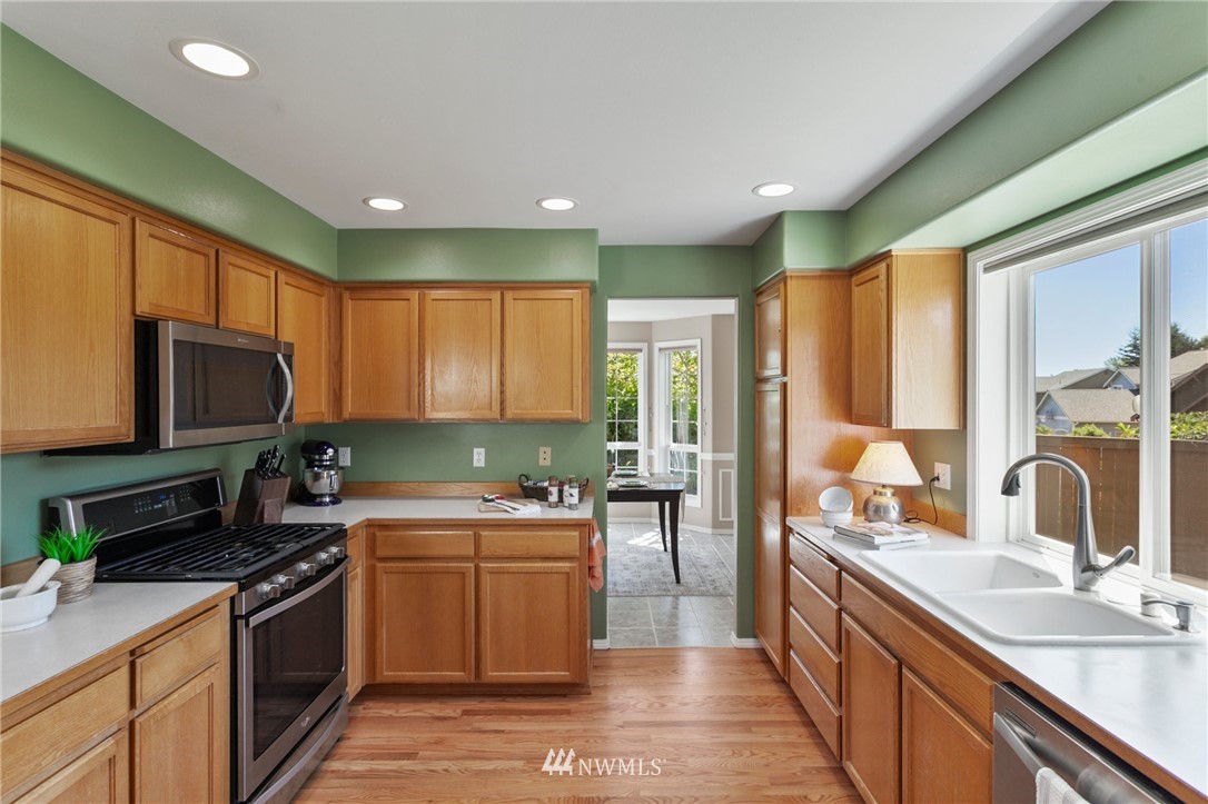 913 232nd Street Southwest Bothell, WA 98021 - Photo 5 of 34 a kitchen with a sink stove and microwave