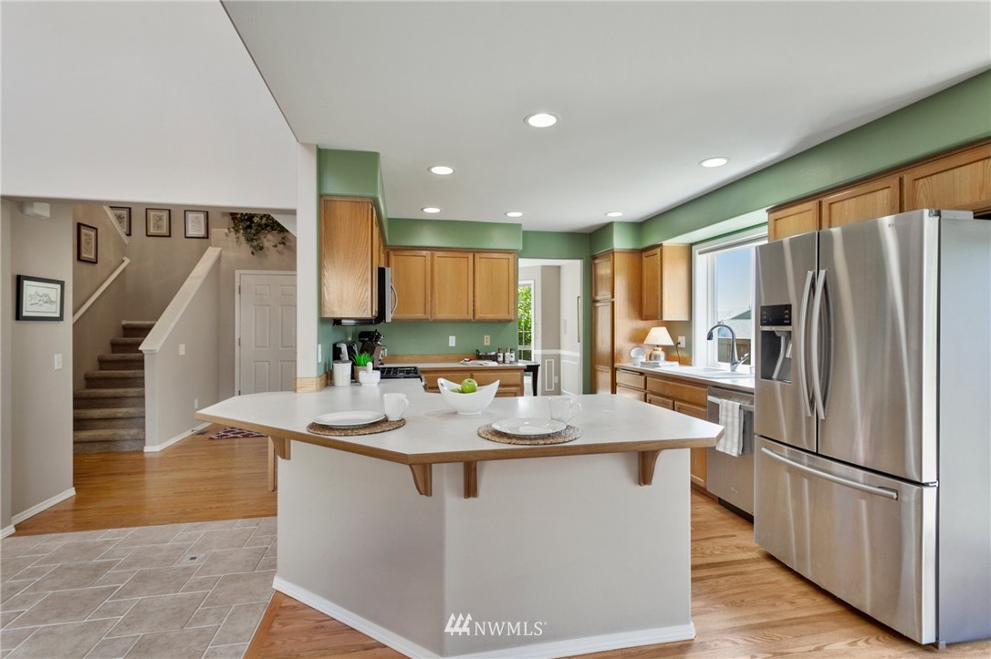 913 232nd Street Southwest Bothell, WA 98021 - Photo 8 of 34 a kitchen with stainless steel appliances granite countertop a refrigerator a sink and a stove