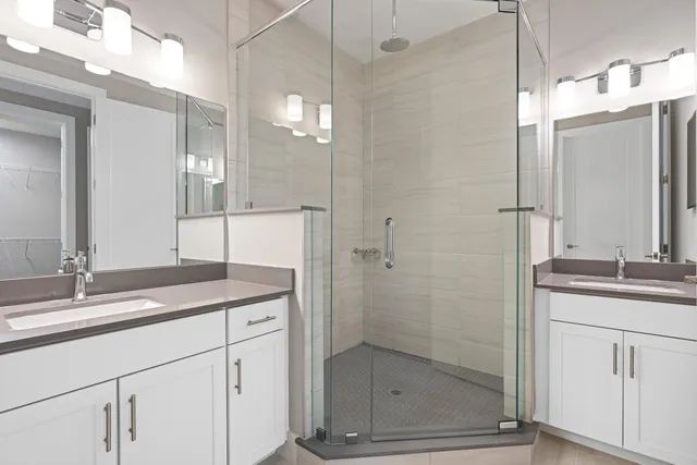 a bathroom with a shower sink and mirror