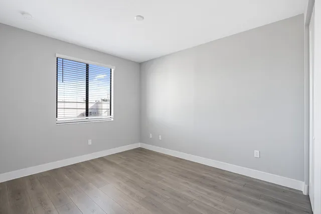wooden floor in an empty room with a window