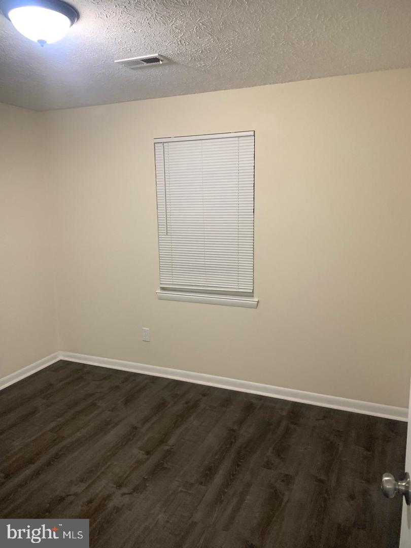 424 Harford Street Perryville, MD 21903 - Photo 14 of 19 an empty room with wooden floor and windows