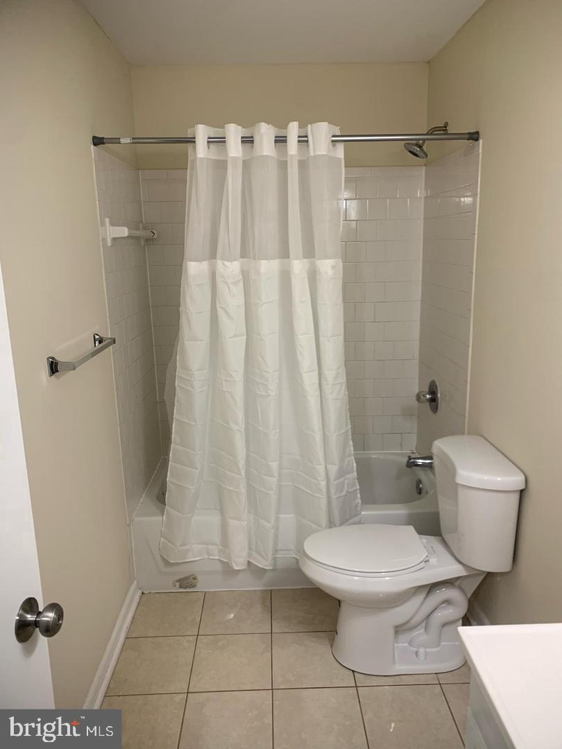 424 Harford Street Perryville, MD 21903 - Photo 16 of 19 a white toilet sitting next to a shower curtain