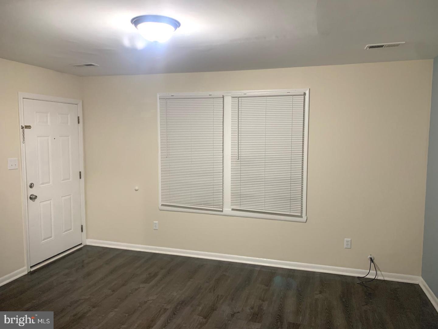 424 Harford Street Perryville, MD 21903 - Photo 4 of 19 an empty room with wooden floor and windows