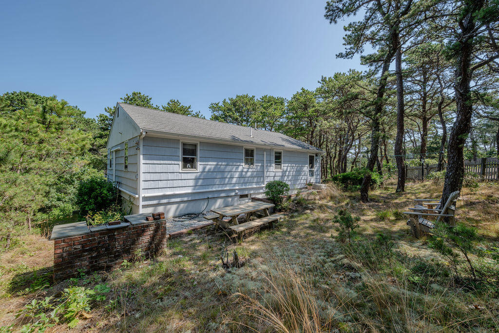 50 Massasoit Road Wellfleet, MA 02667 - Photo 31 of 39 a view of a house with a yard and plants