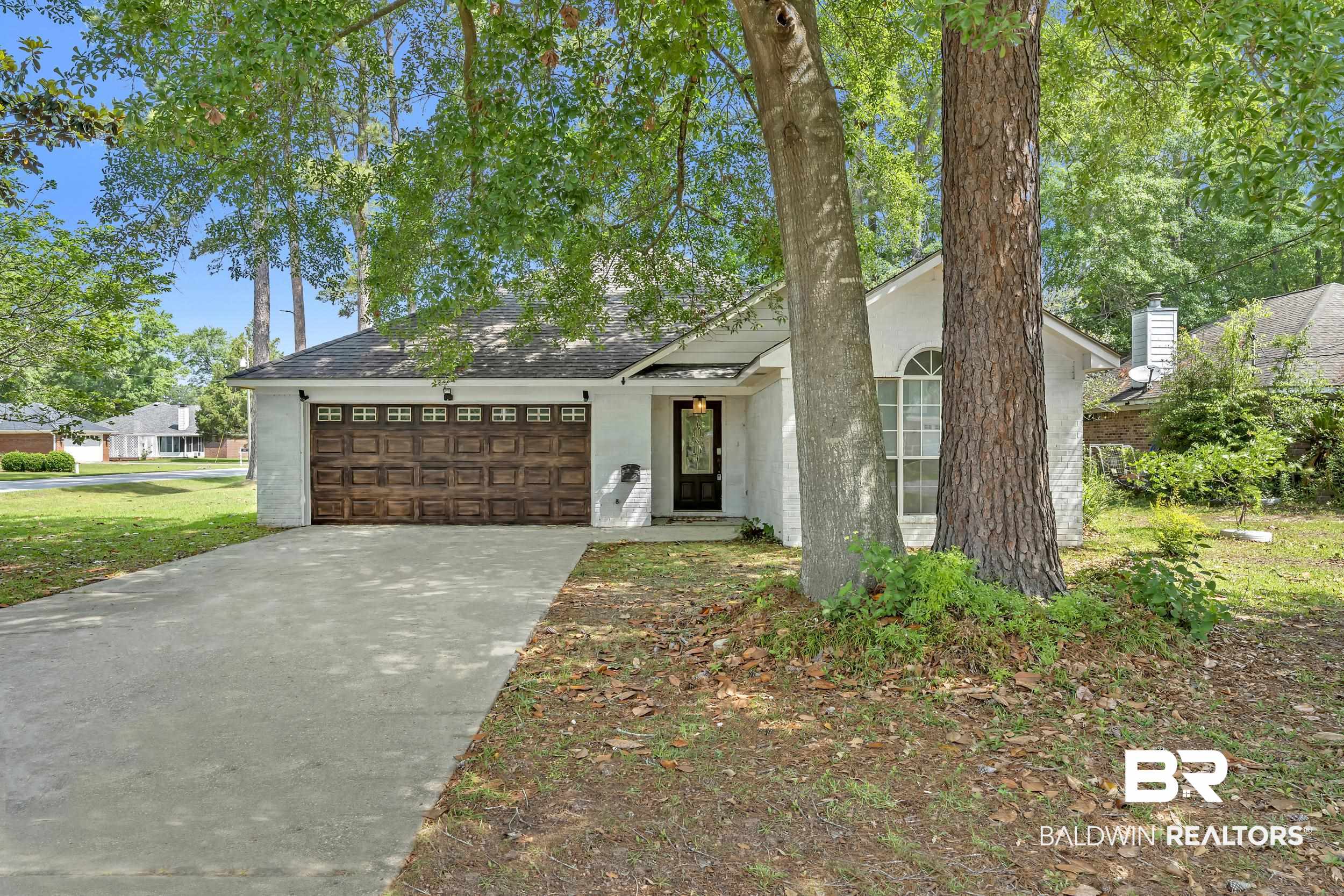 509 Loblolly Court Foley, AL 36535 - Photo 1 of 26 White stucco exterior featuring a wood-finish garage door