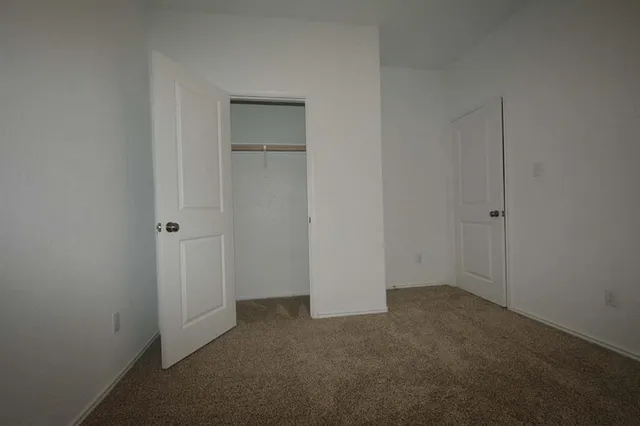 an empty room with closet area