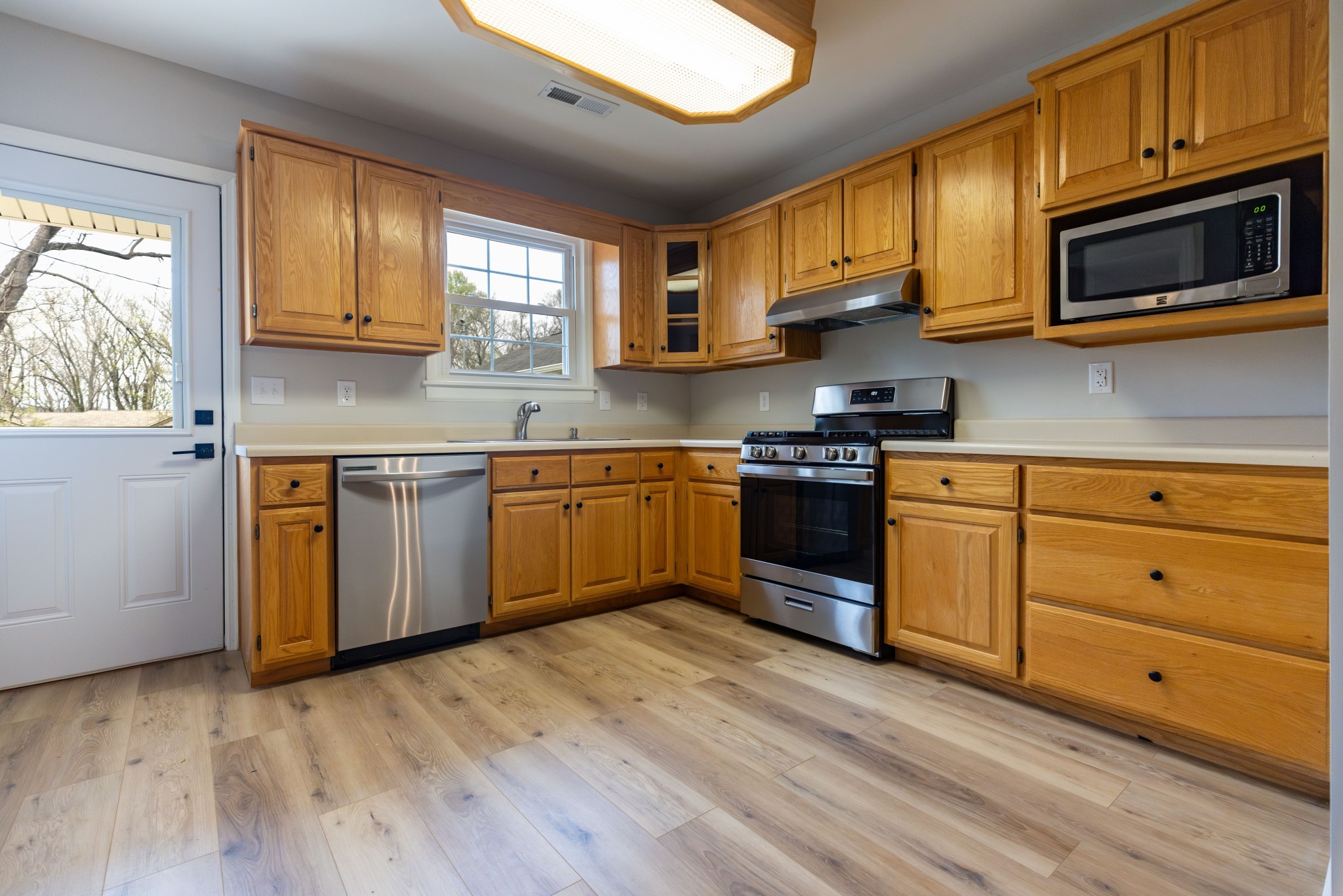 130 Kinneys School Road Springfield, TN 37172 - Photo 5 of 19 a kitchen with stainless steel appliances granite countertop wooden cabinets a sink a stove a refrigerator with grey cabinets and wooden floor