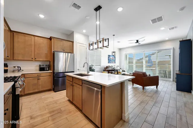 a kitchen with a sink stove and wooden cabinets