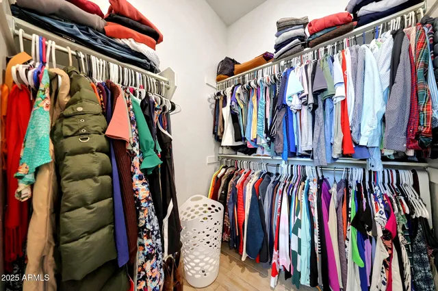 a view of walk in closet with clothes