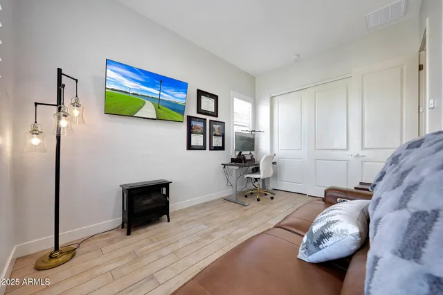 a living room with furniture and a wooden floor