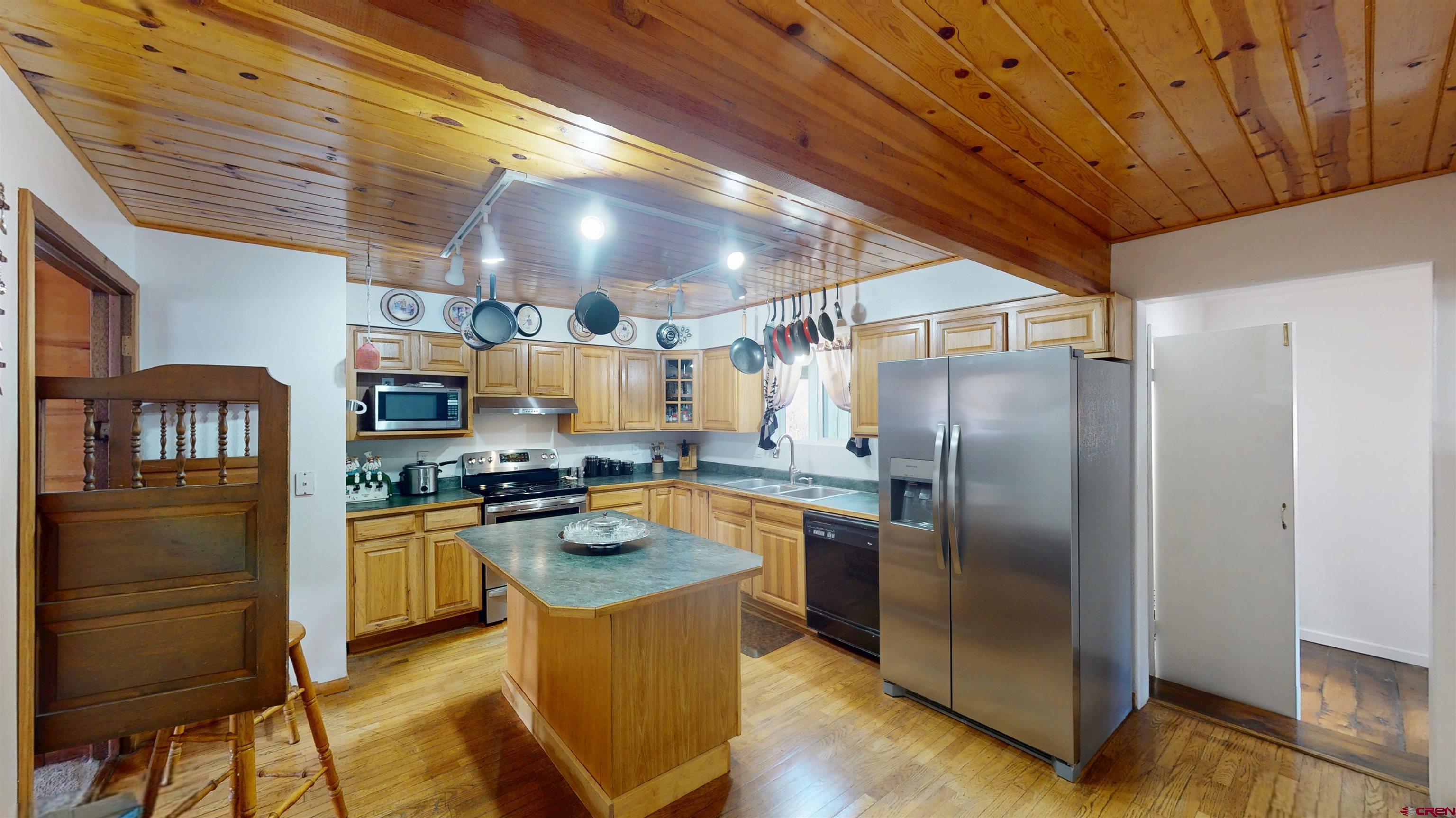 19253 Stevens Gulch Road Paonia, CO 81428 - Photo 20 of 43 a kitchen with granite countertop stainless steel appliances a stove refrigerator and cabinets