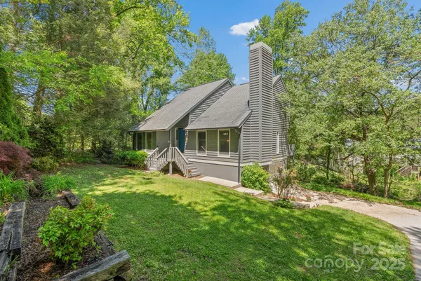 a house with green field in front of it