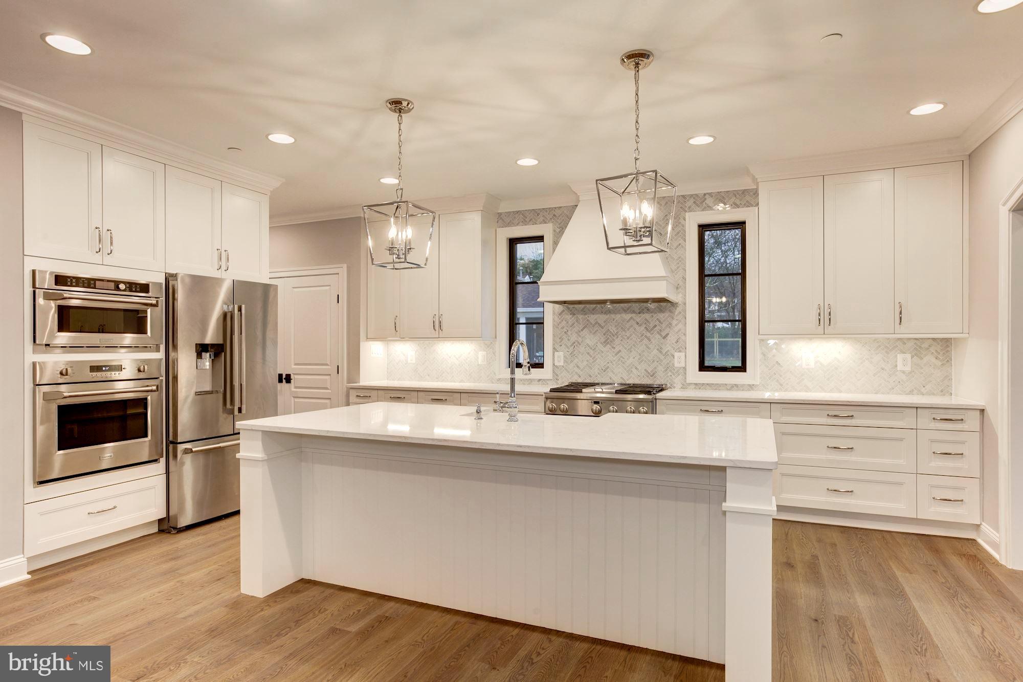 1601 Wrightson Drive McLean, VA 22101 - Photo 105 of 112 a large kitchen with granite countertop a stove a sink a center island and wooden floor