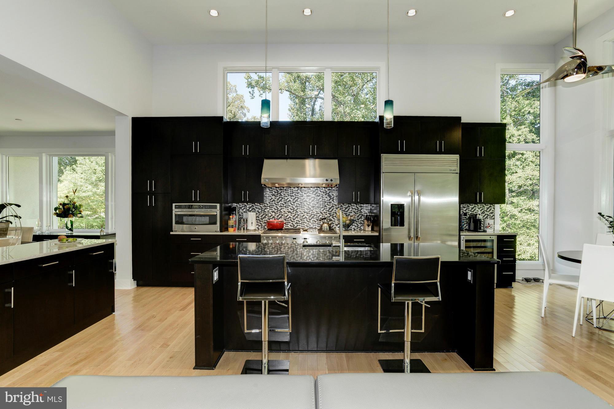 1601 Wrightson Drive McLean, VA 22101 - Photo 12 of 112 a kitchen with stainless steel appliances kitchen island granite countertop a sink and cabinets