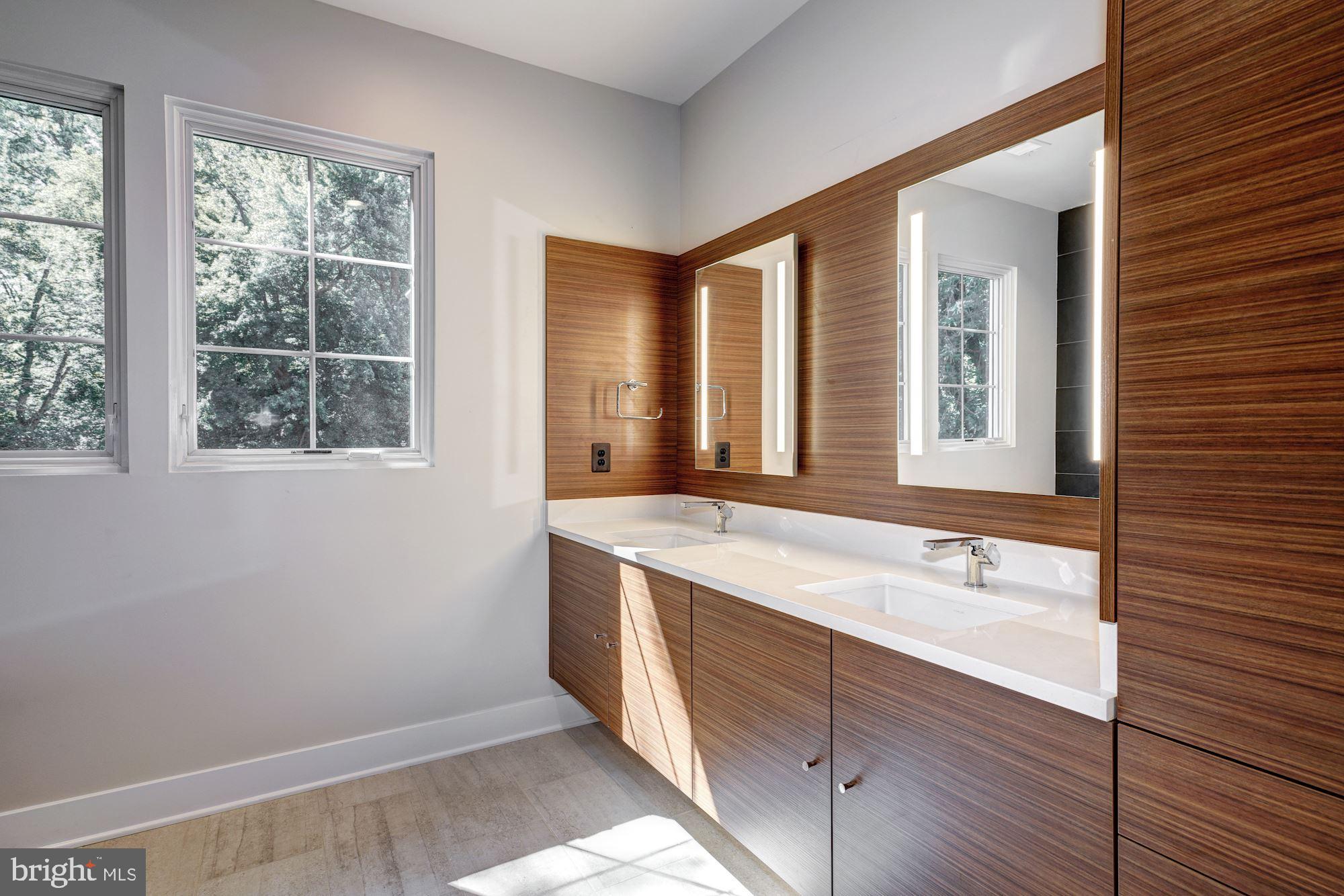 1601 Wrightson Drive McLean, VA 22101 - Photo 63 of 112 a bathroom with a sink and a large mirror next to a window