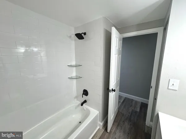 a bathroom with a bathtub and shower