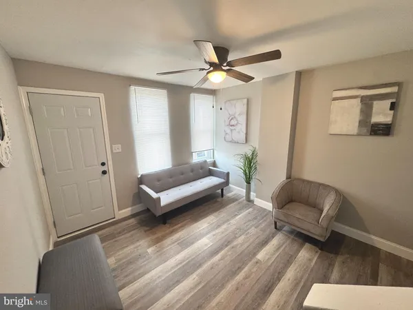 a living room with a bed furniture and a window