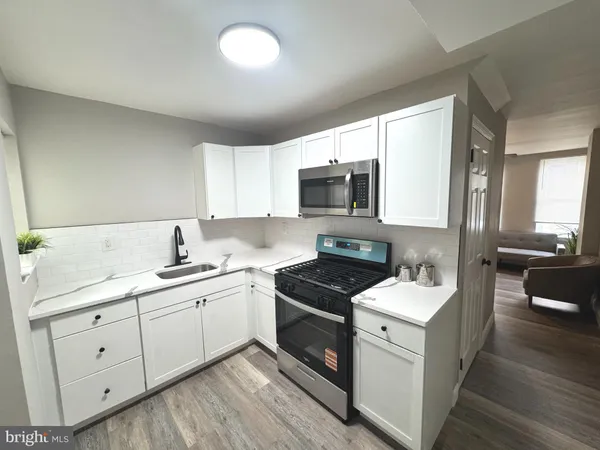 a kitchen with a sink stove and microwave