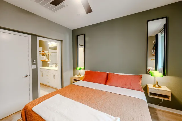 a bedroom with a bed and a chandelier