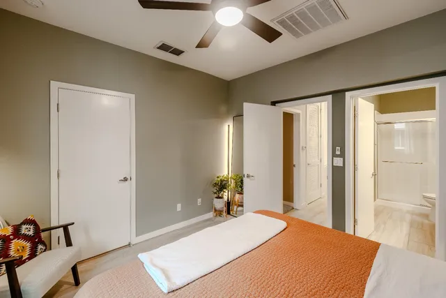 a bedroom with a bed and a chandelier