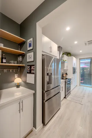 a kitchen with cabinets and stainless steel appliances