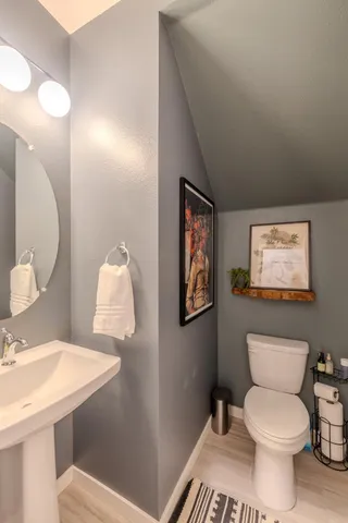 a white toilet sitting next to a bathroom sink