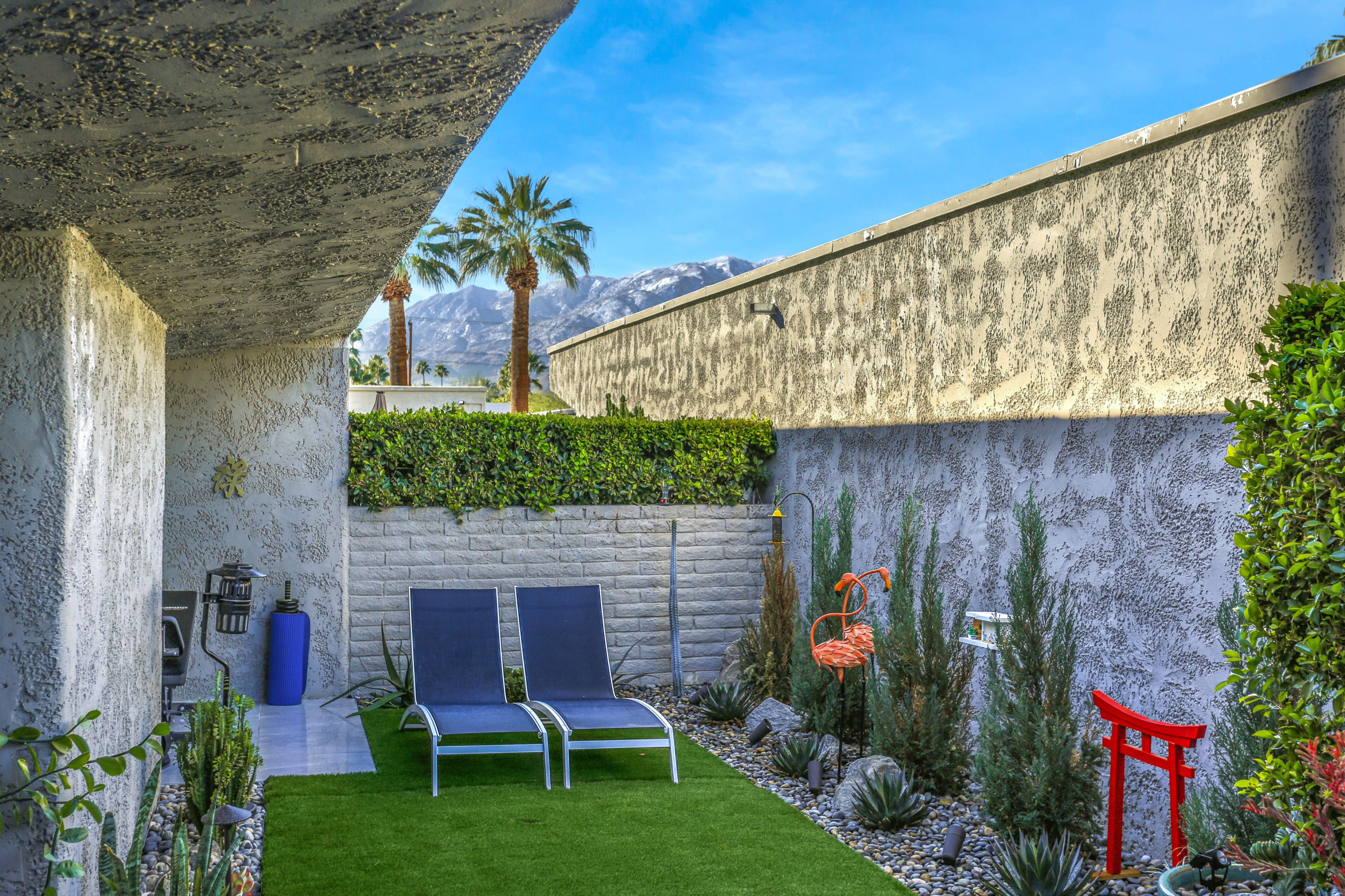 1111 Ramon Road, Unit 70 Palm Springs, CA 92264 - Photo 22 of 31 a backyard of a house with table and chairs plants and large tree