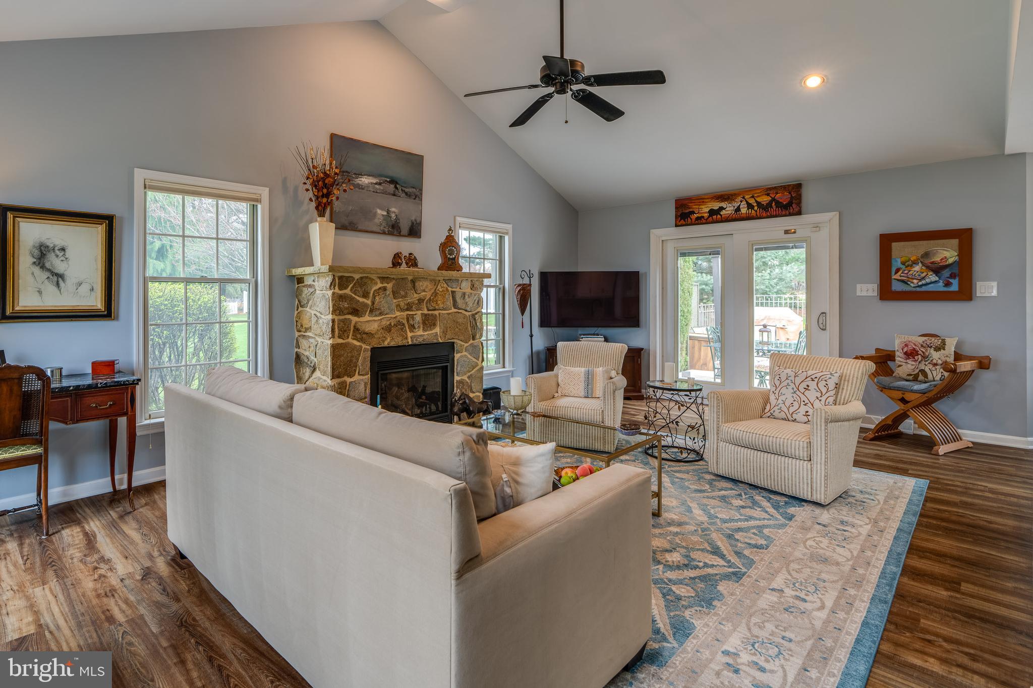 318 Portland Place Lititz, PA 17543 - Photo 14 of 39 a living room with furniture a fireplace and a flat screen tv
