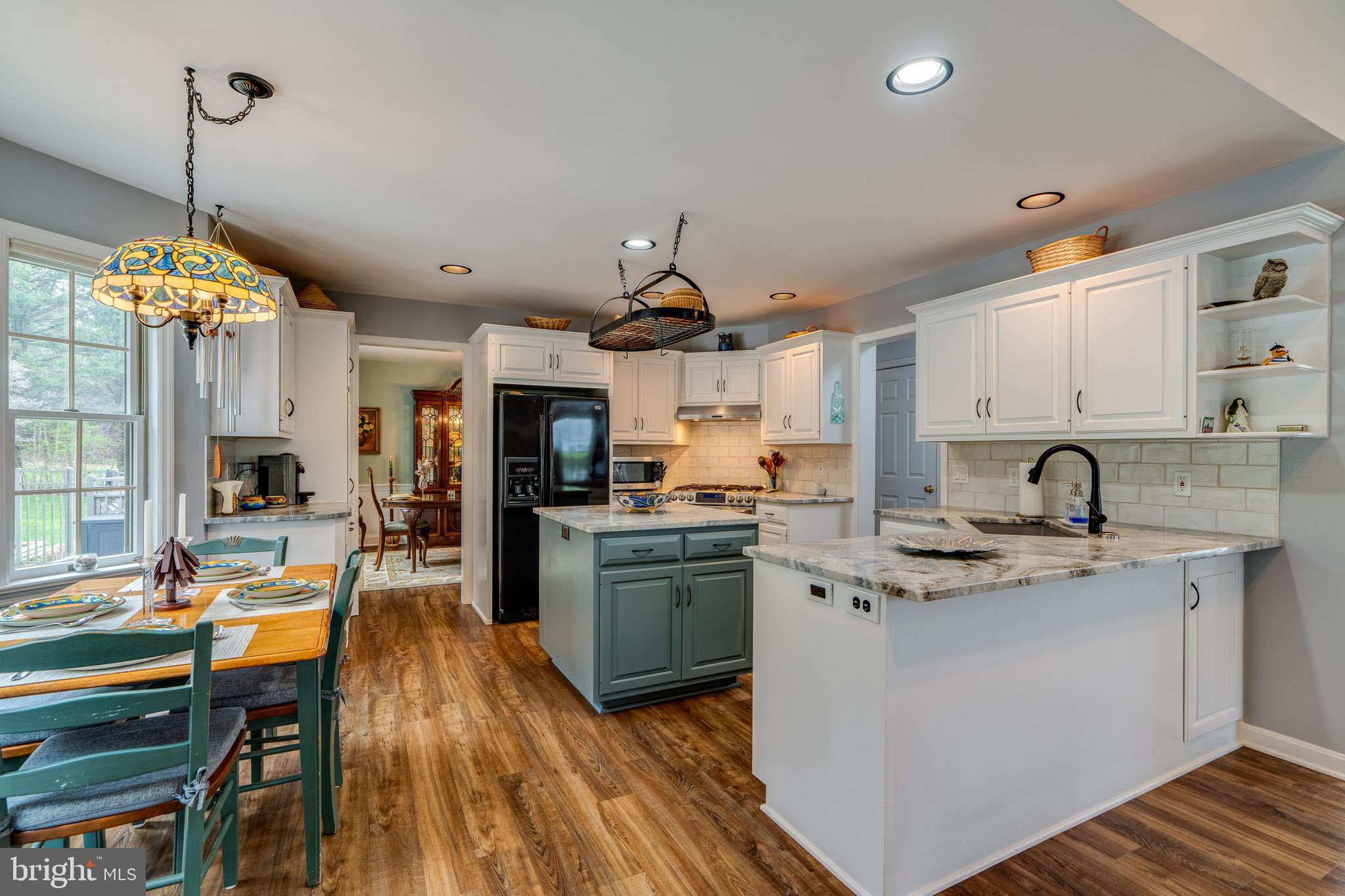 318 Portland Place Lititz, PA 17543 - Photo 17 of 39 a kitchen with kitchen island granite countertop a sink cabinets and wooden floor