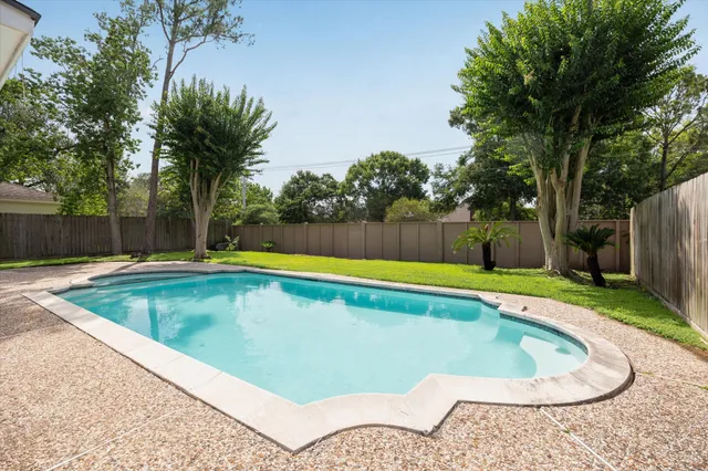 a view of a swimming pool with a yard