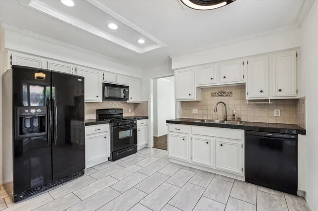 a kitchen with granite countertop stainless steel appliances and cabinets