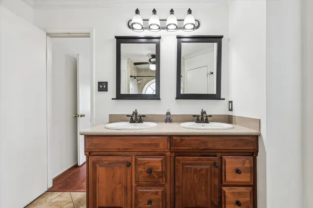 a bathroom with a sink vanity and mirror