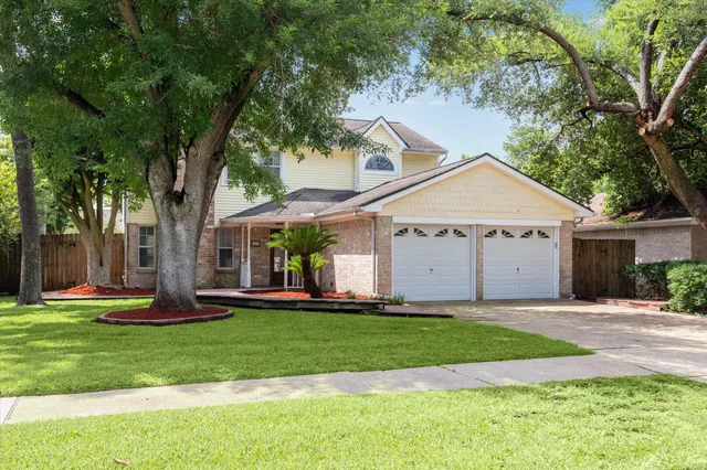 a front view of a house with a yard and road