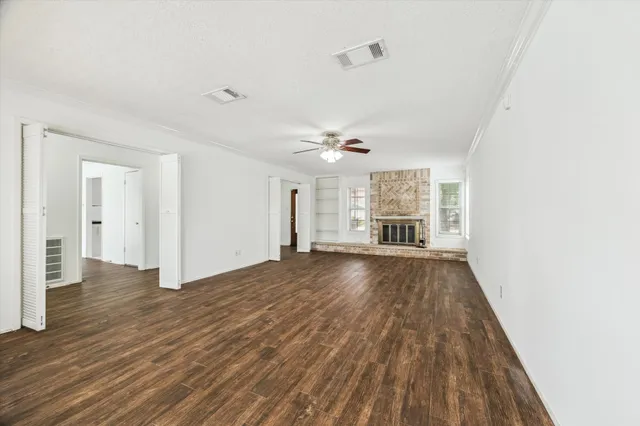 wooden floor in an empty room with a fireplace