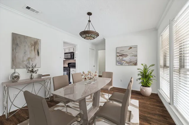 a view of a dining room with furniture window and wooden floor