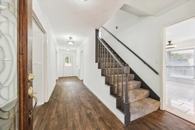 a view of entryway and hall with wooden floor