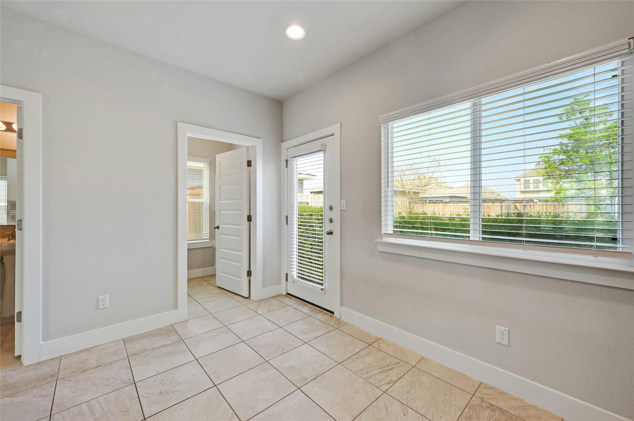 121 Switchgrass Street San Marcos, TX 78666 - Photo 15 of 33 Kitchen with view into the laundry room and door to the private backyard.