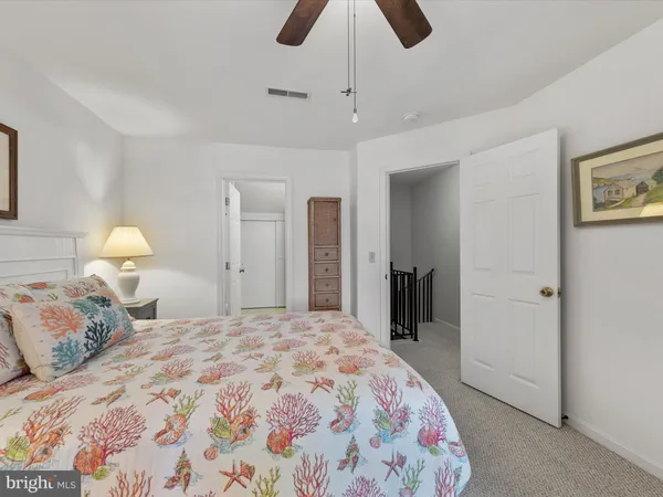 a bedroom with a bed dresser and a window