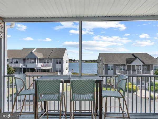 a balcony with table and chairs